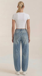 Women’s wide-leg jeans in light blue wash, back view with patch pockets.