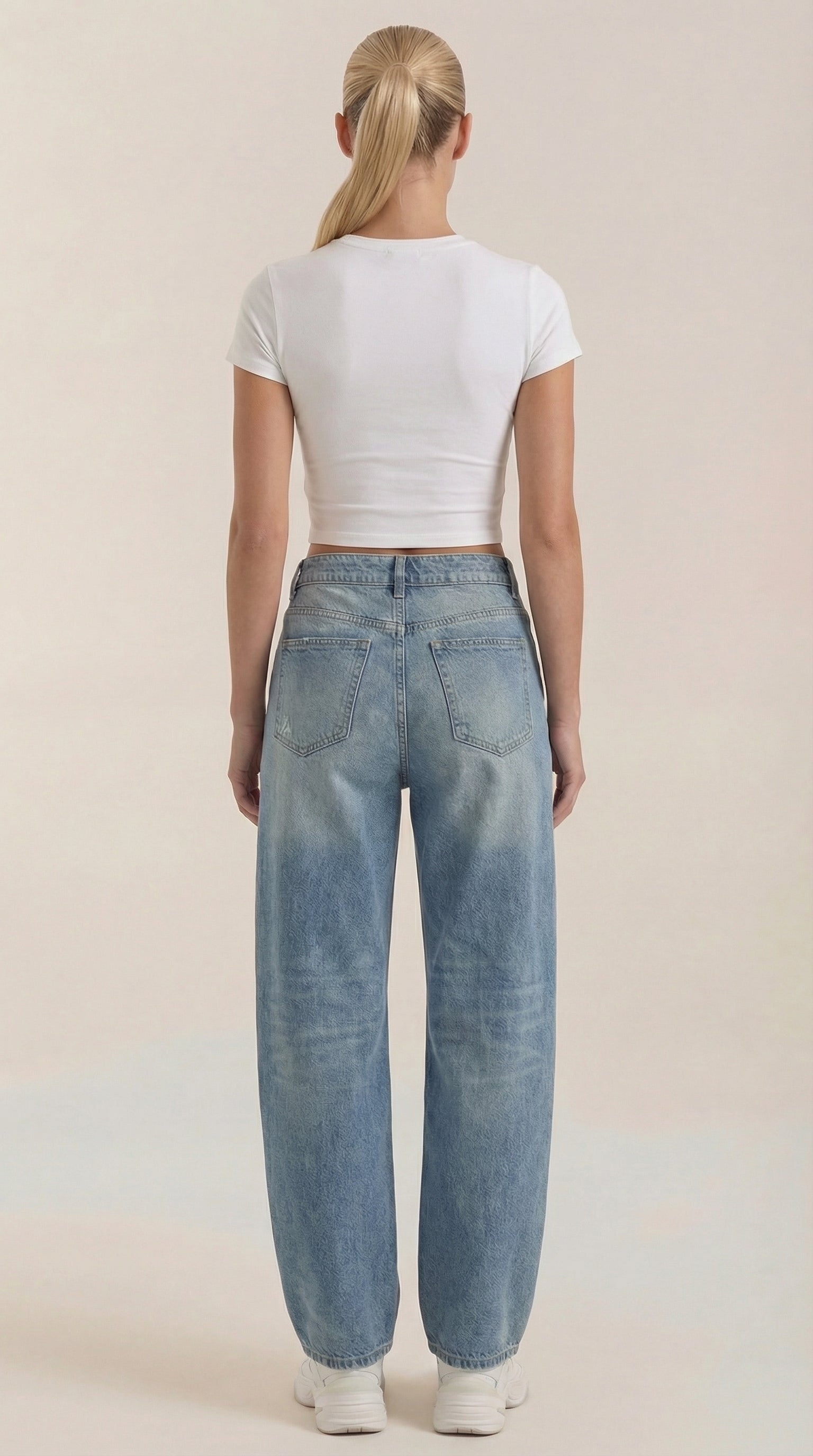 Women’s wide-leg jeans in light blue wash, back view with patch pockets.