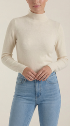 Beige cotton mock neck top close-up with long sleeves and fitted waist