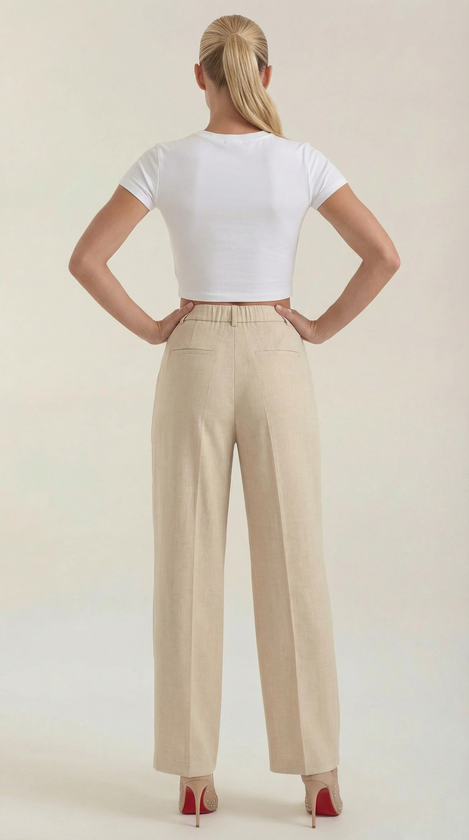 Women’s pleated high-rise wide-leg pants, light beige shown from the back