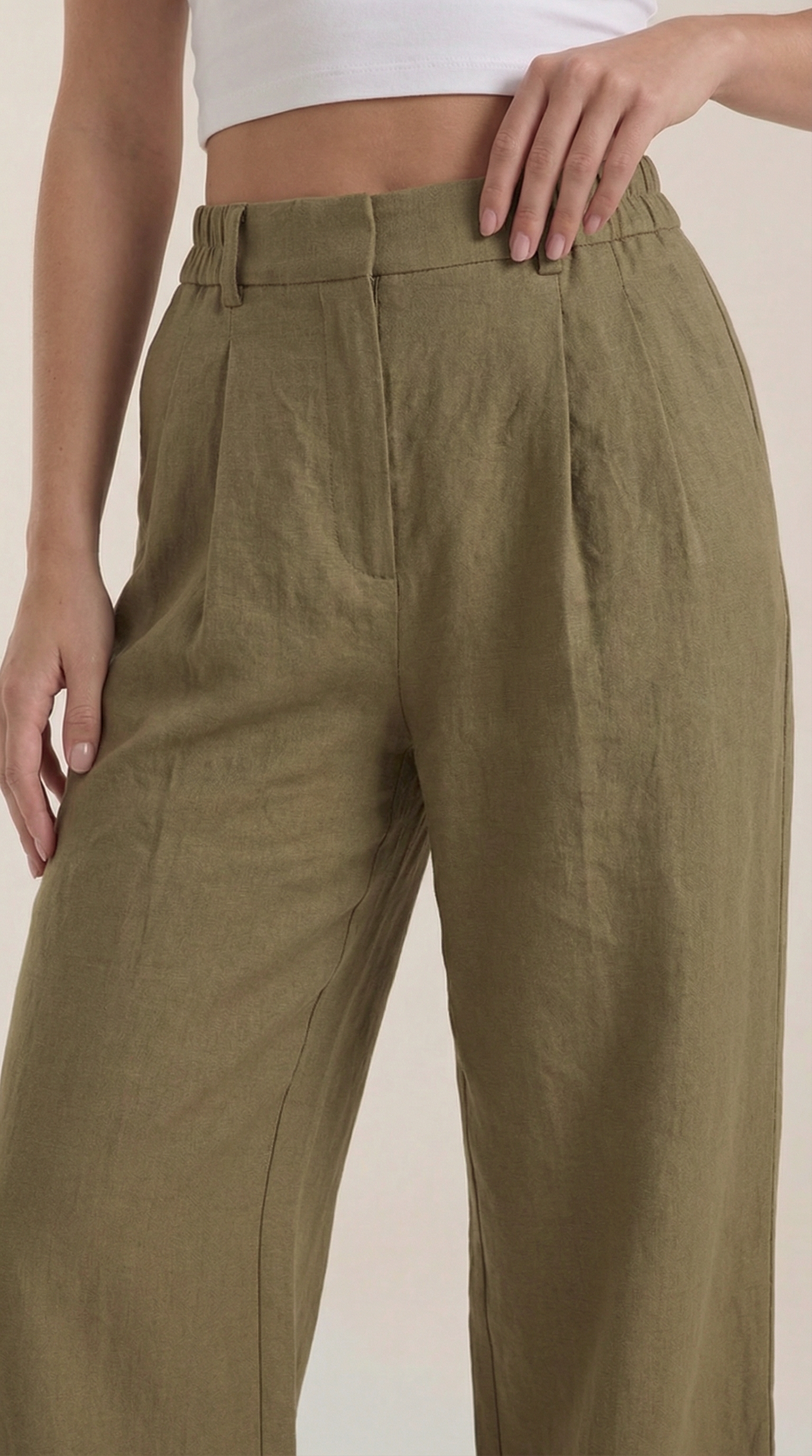 Olive green pleated high-rise wide-leg pants with front pintucks and elastic waist