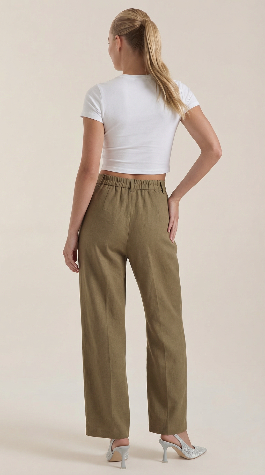 Olive green pleated high-rise wide-leg pants with elastic waist and ankle-length legs