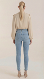 Beige draped long-sleeve blouse, back view, cowl neck and gathered shoulders