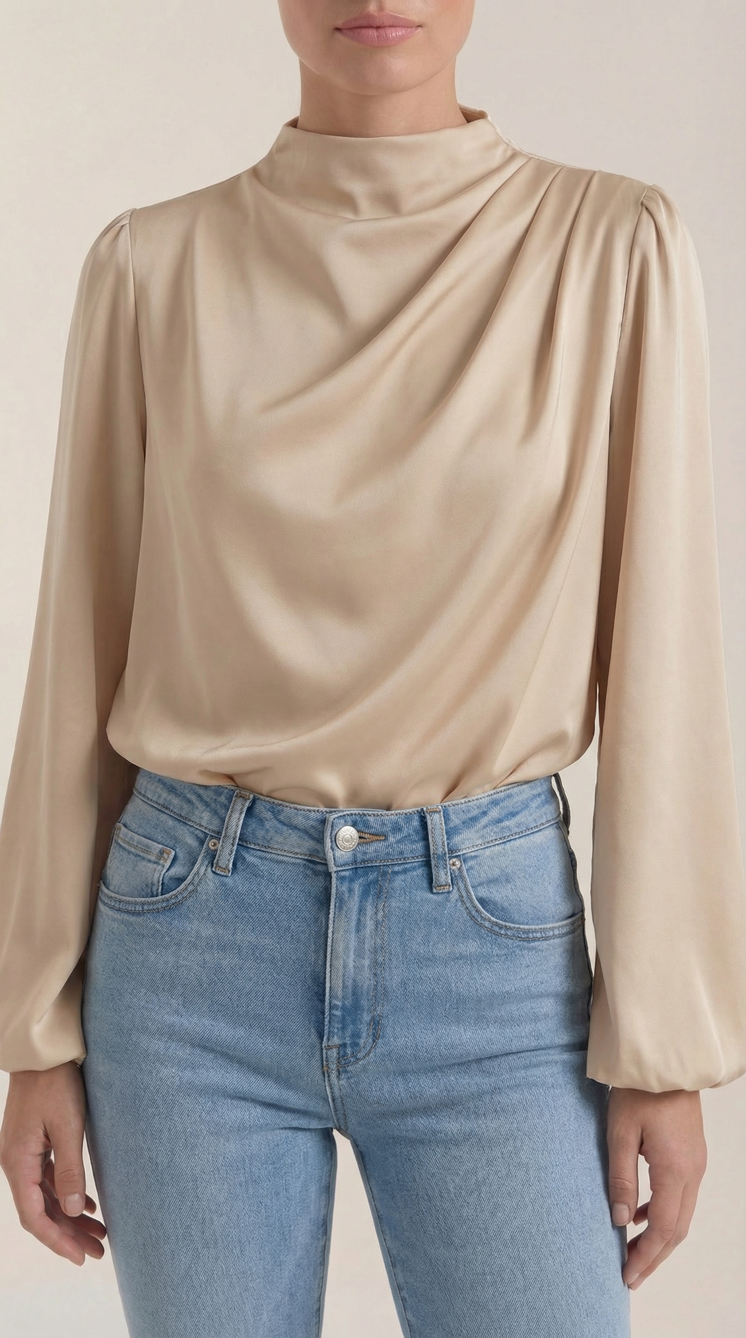 Beige draped blouse close-up with cowl neck and soft gathered front