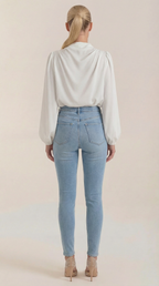 Back view draped long-sleeve blouse in white with pleated yoke and cowl neck