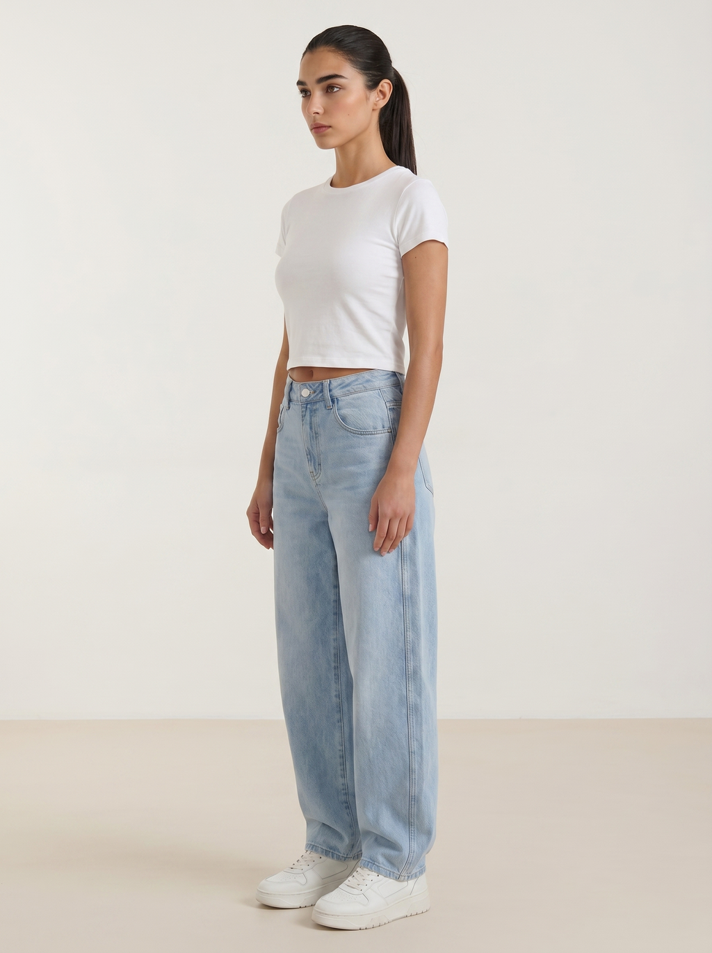 Women’s wide-leg jeans in light blue wash, button front, belt loops, front pockets.