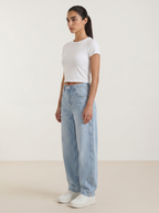 Women’s wide-leg jeans in light blue wash, button front, belt loops, front pockets.