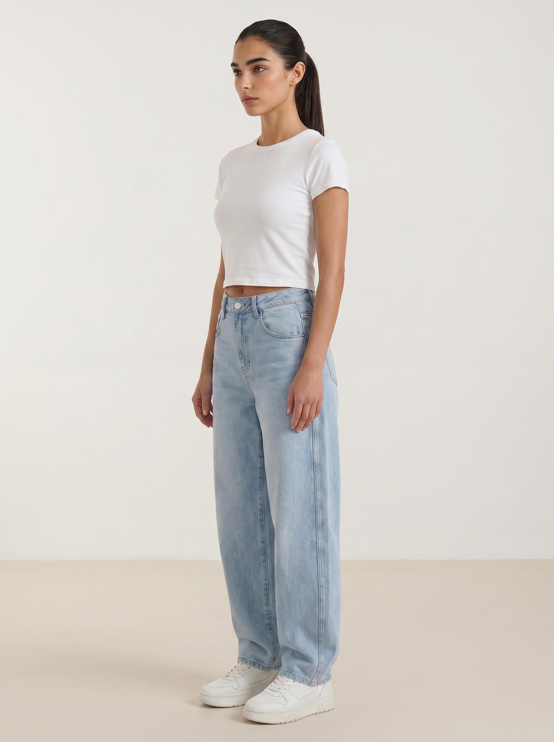 Women’s wide-leg jeans in light blue wash, button front, belt loops, front pockets.