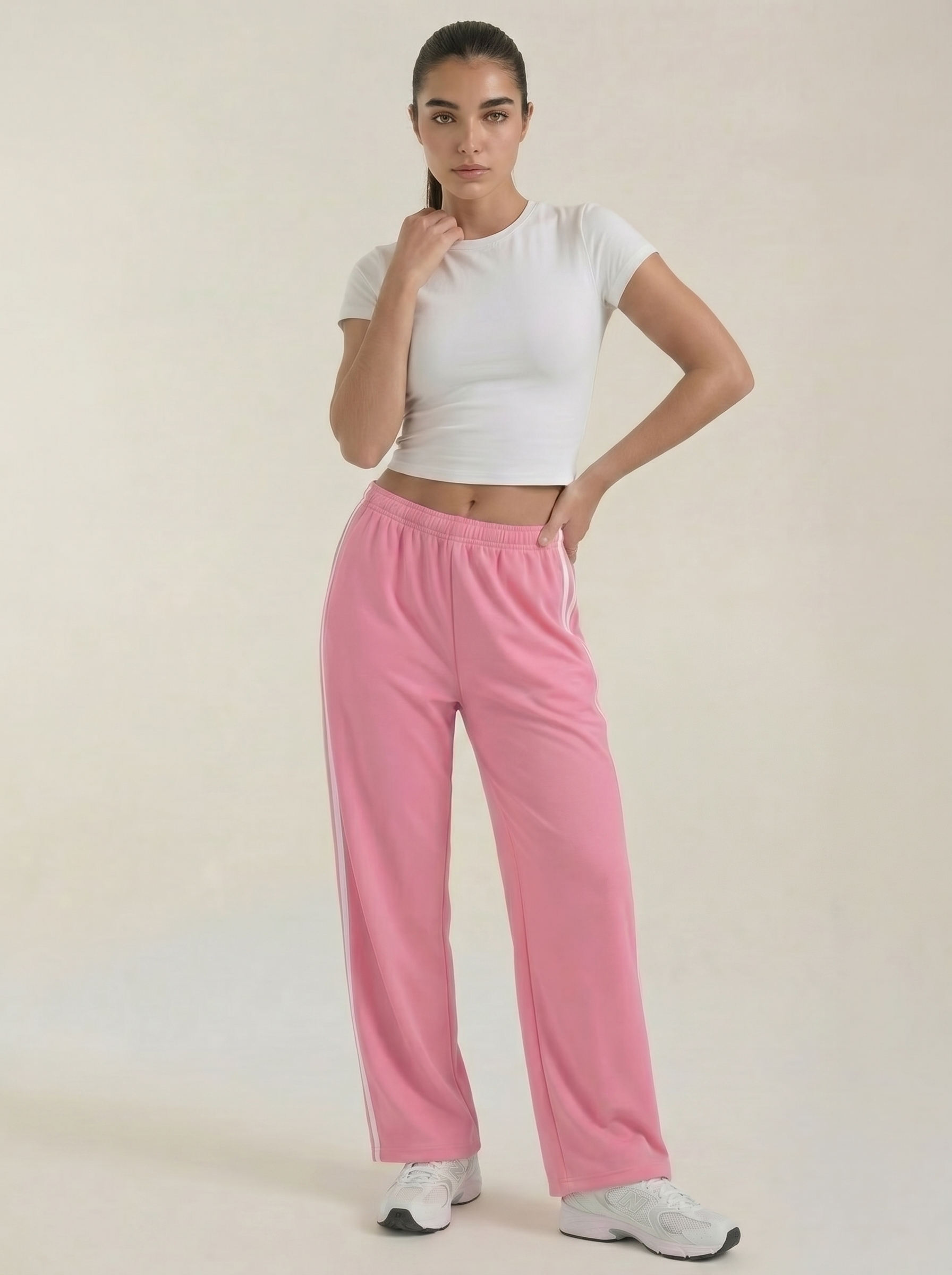 Pink wide-leg track pants with white side stripes and drawstring waist