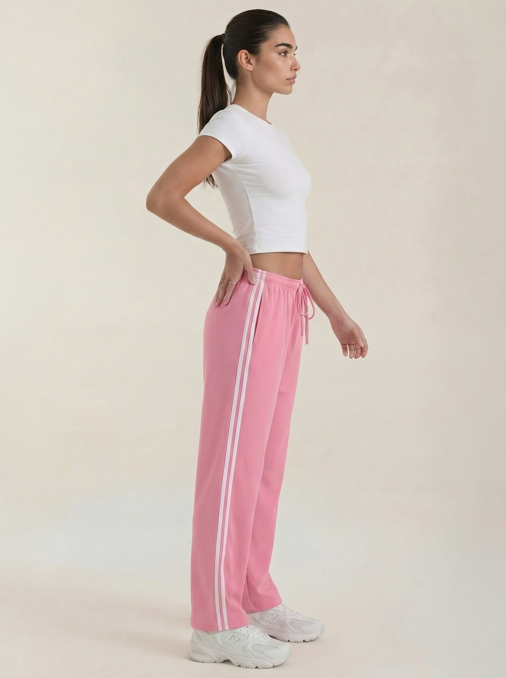 Pink wide-leg track pants with white side stripes, drawstring and elastic waist