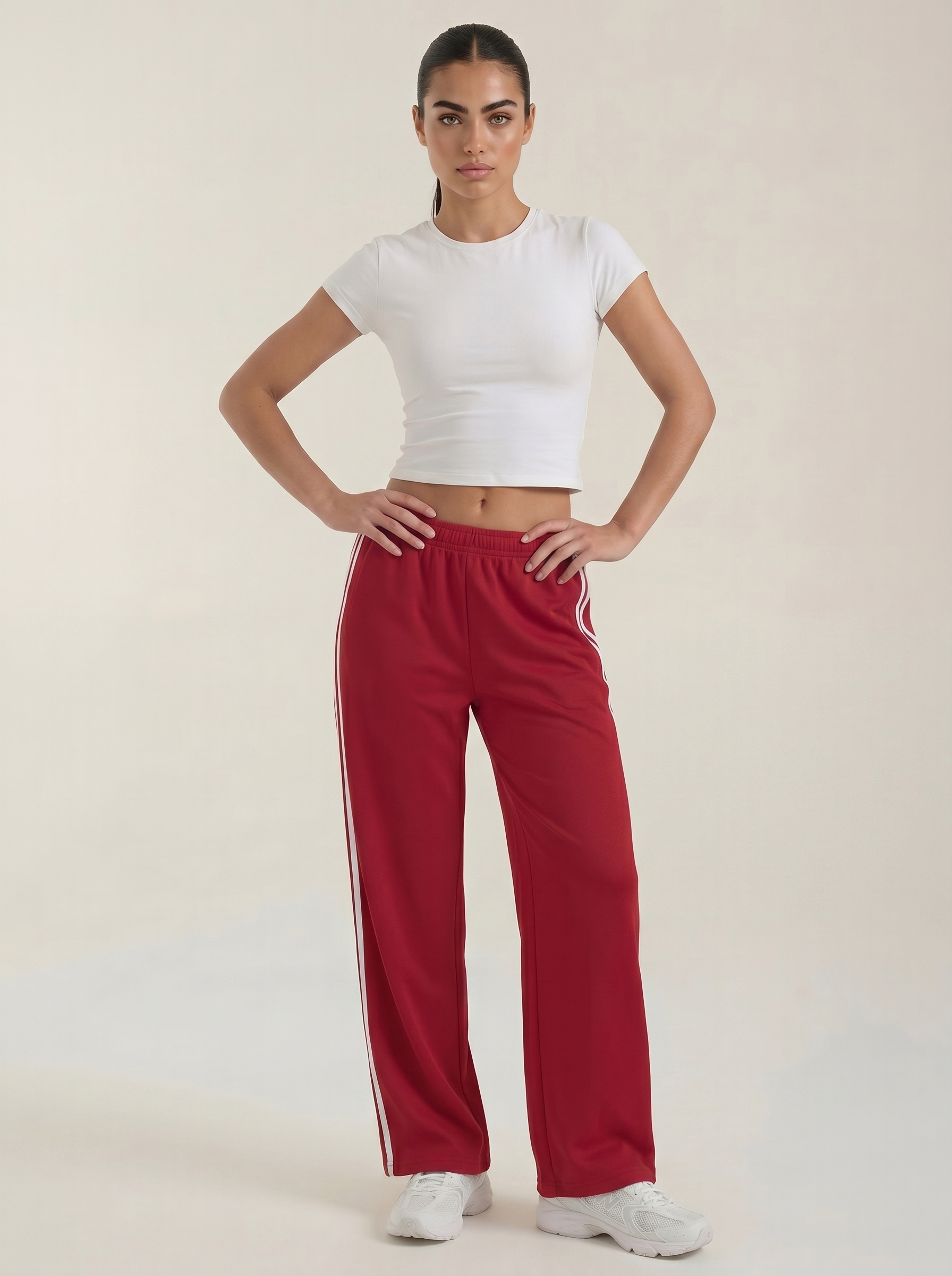Red wide-leg track pants with white side stripes and drawstring waist