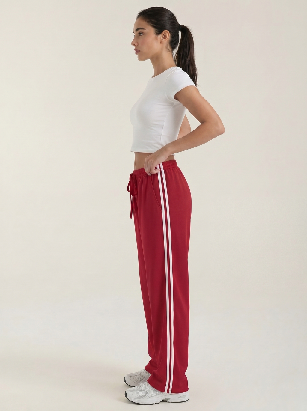 Red wide-leg track pants with white side stripes and ruched drawstring waist