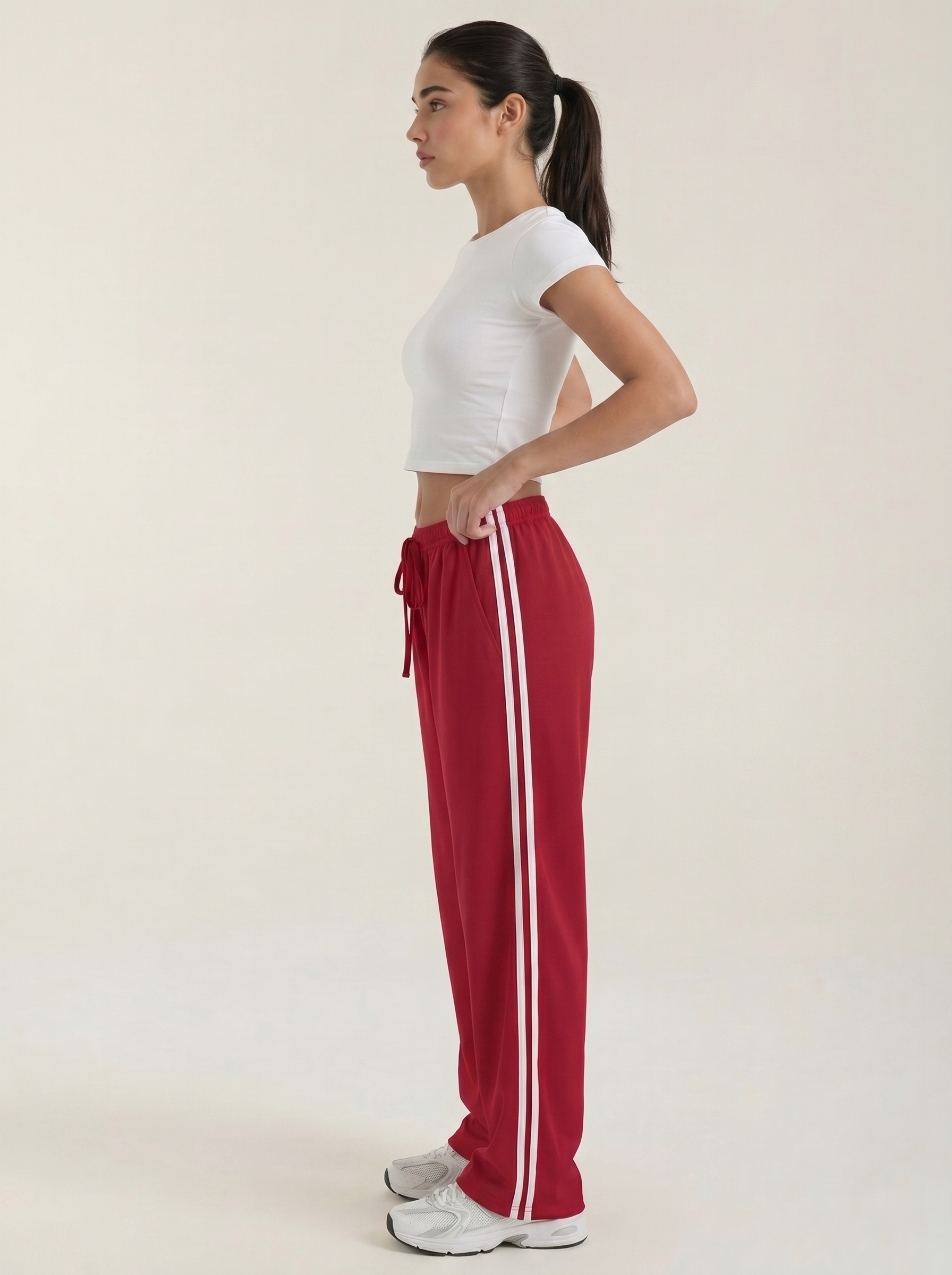 Red wide-leg track pants with white side stripes and ruched drawstring waist