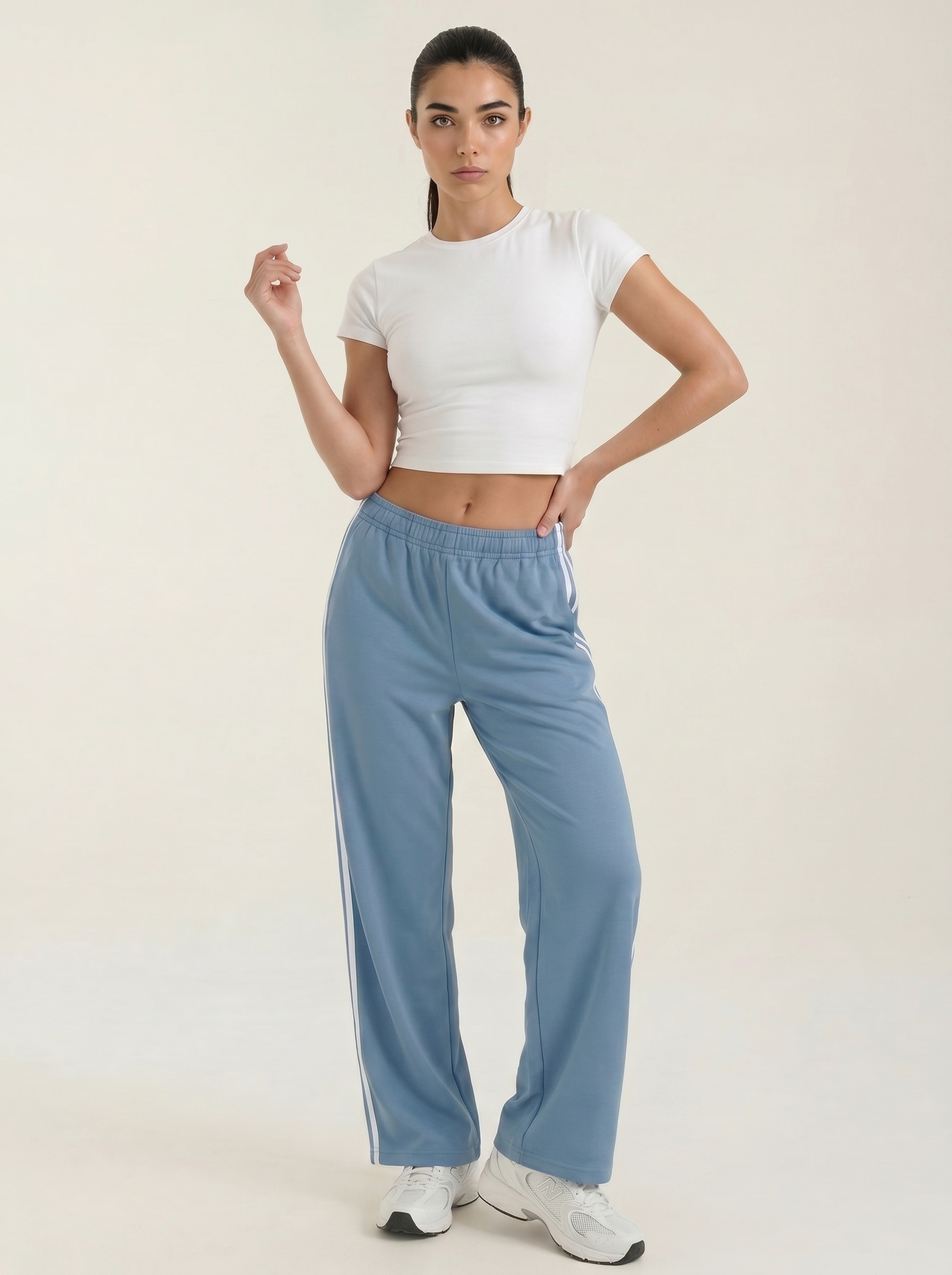 Blue wide-leg track pants with white side stripes and elastic drawstring waist