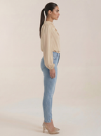Beige draped long-sleeve blouse, side view, with cowl neckline and loose sleeves