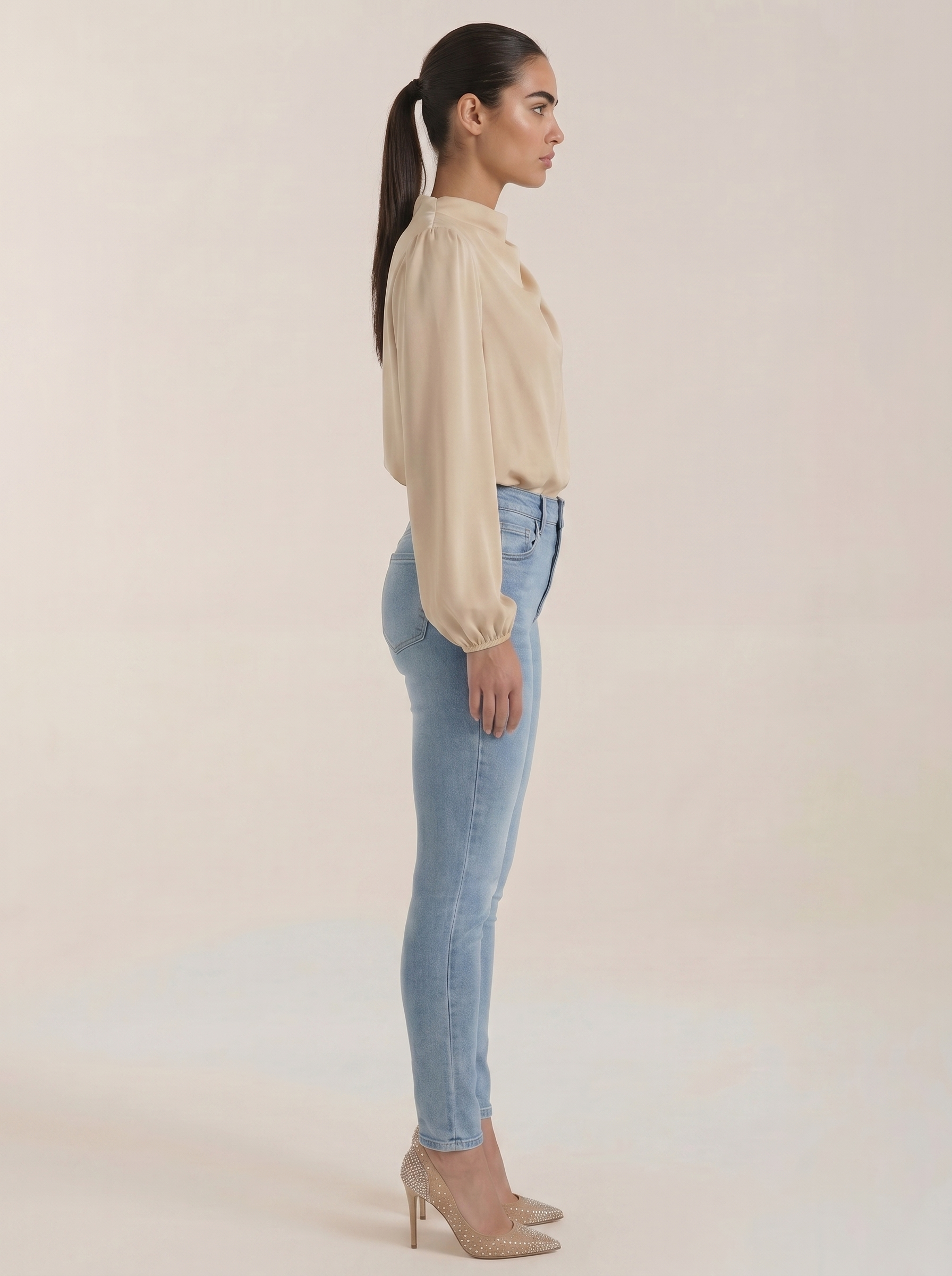 Beige draped long-sleeve blouse, side view, with cowl neckline and loose sleeves