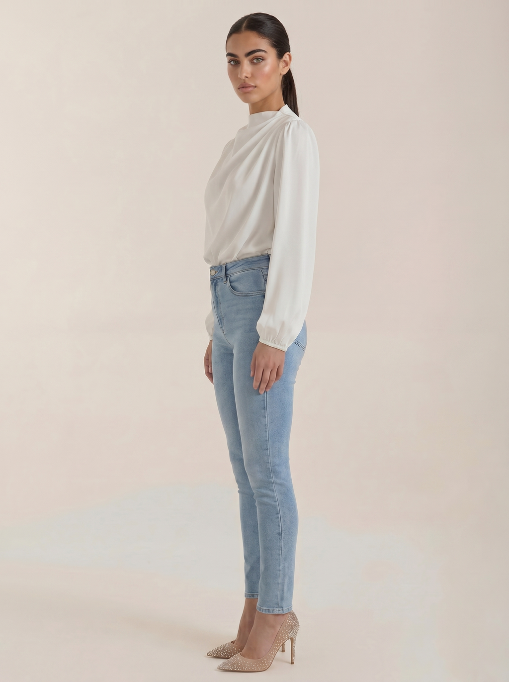 White draped long-sleeve blouse, side view, with cowl neck and gathered shoulders